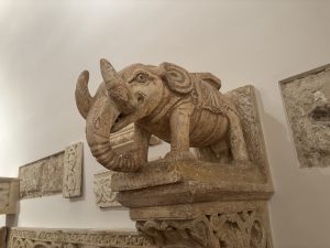 Carved stone elephant sculpture mounted on an ornate pedestal